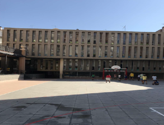 Image of a school yard with no greenery and heat absorbing materials