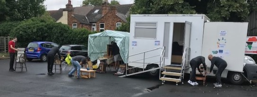Volunteers and workers preparing furniture for a makeover, during the COVID 19 pandemic.