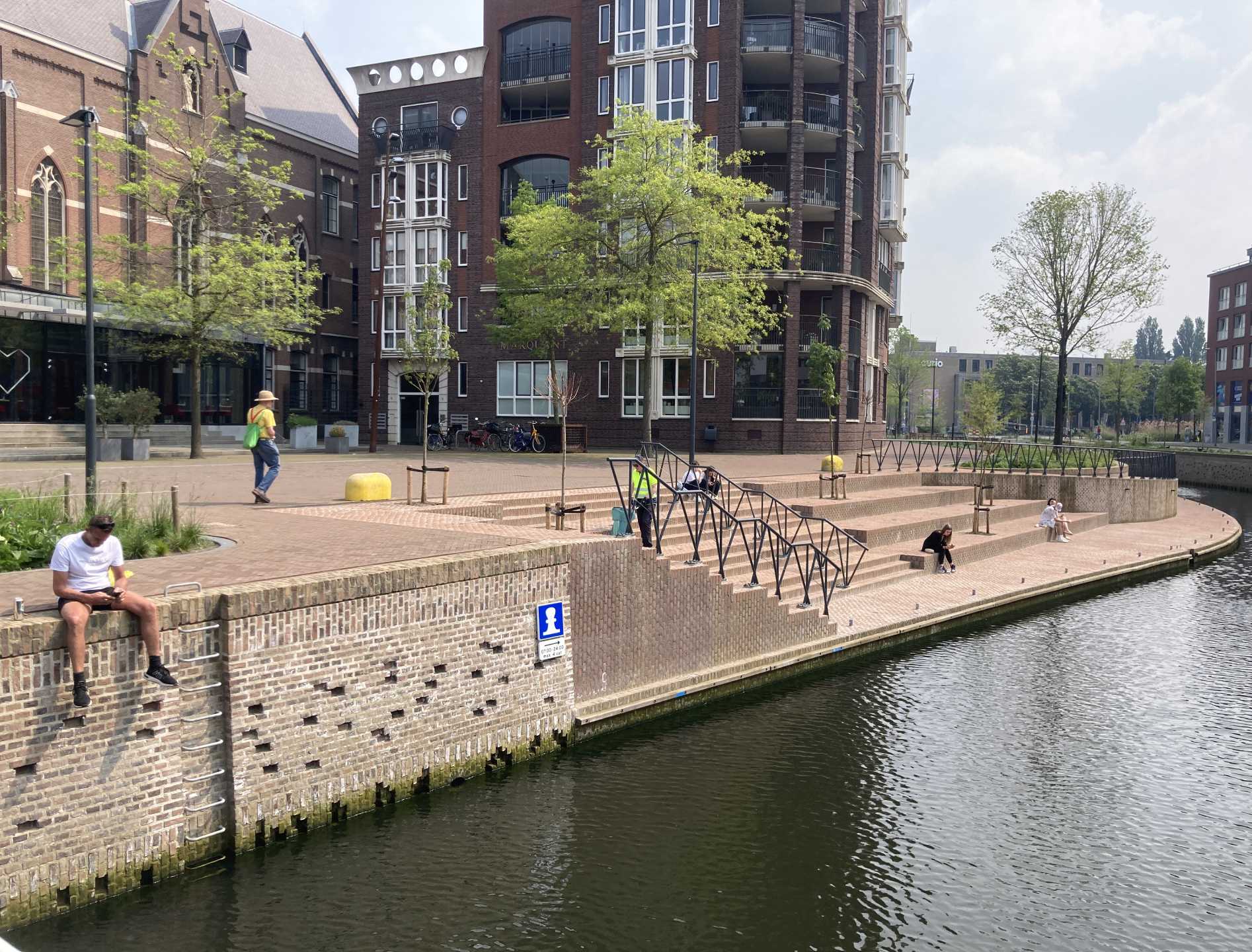 people sitting at the stairs of the quays