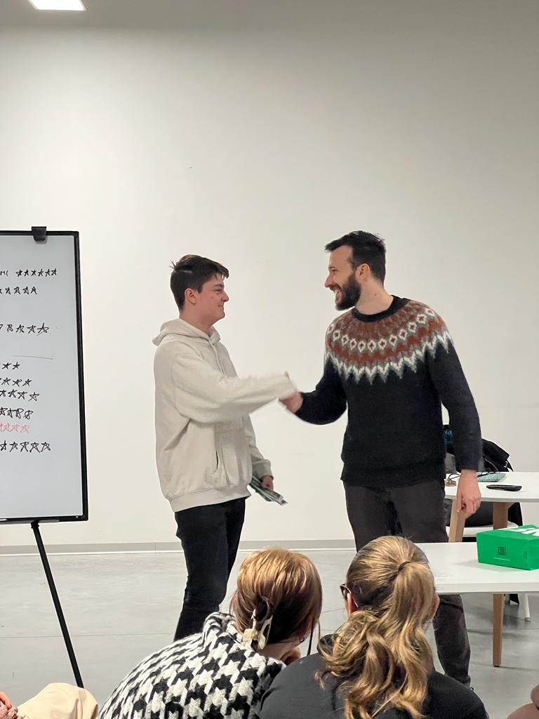 Figure 1 – Ferrara’s Deputy Mayor Alessandro Balboni greeting one of the winners of the Datathon