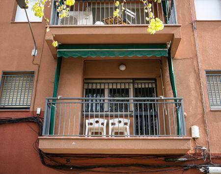 Balcony of a renovated flat with two white chais