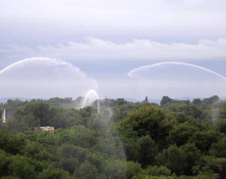 Water cannons for pre-suppression wetting in a wildland-urban interface environment